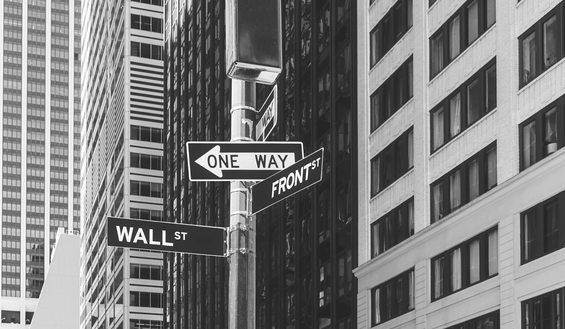 Wall Street, Front Street and One Way signs, selective focus, New York City, USA.